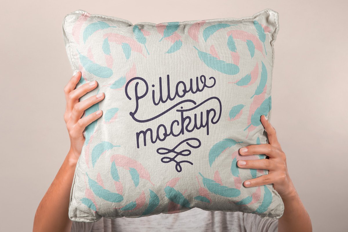 Free Hand holding Pillow PSD Mockup